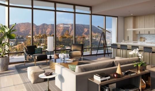 Penthouse-style living room with large windows and warm sunset tone